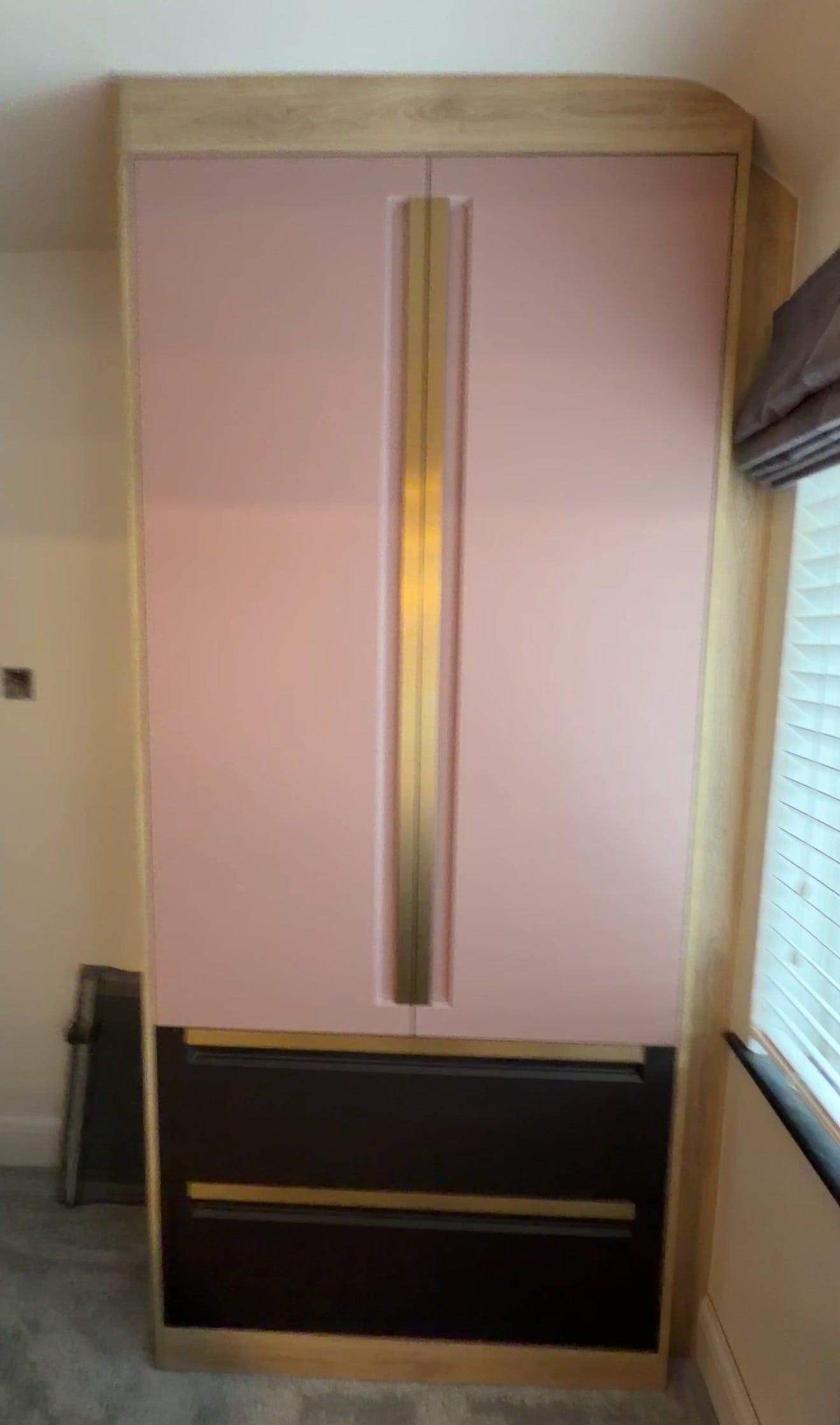 Tall dusky pink Manhattan cupboard with its built-in brass handle over coffee supermatt drawers, in the same Bramcote office