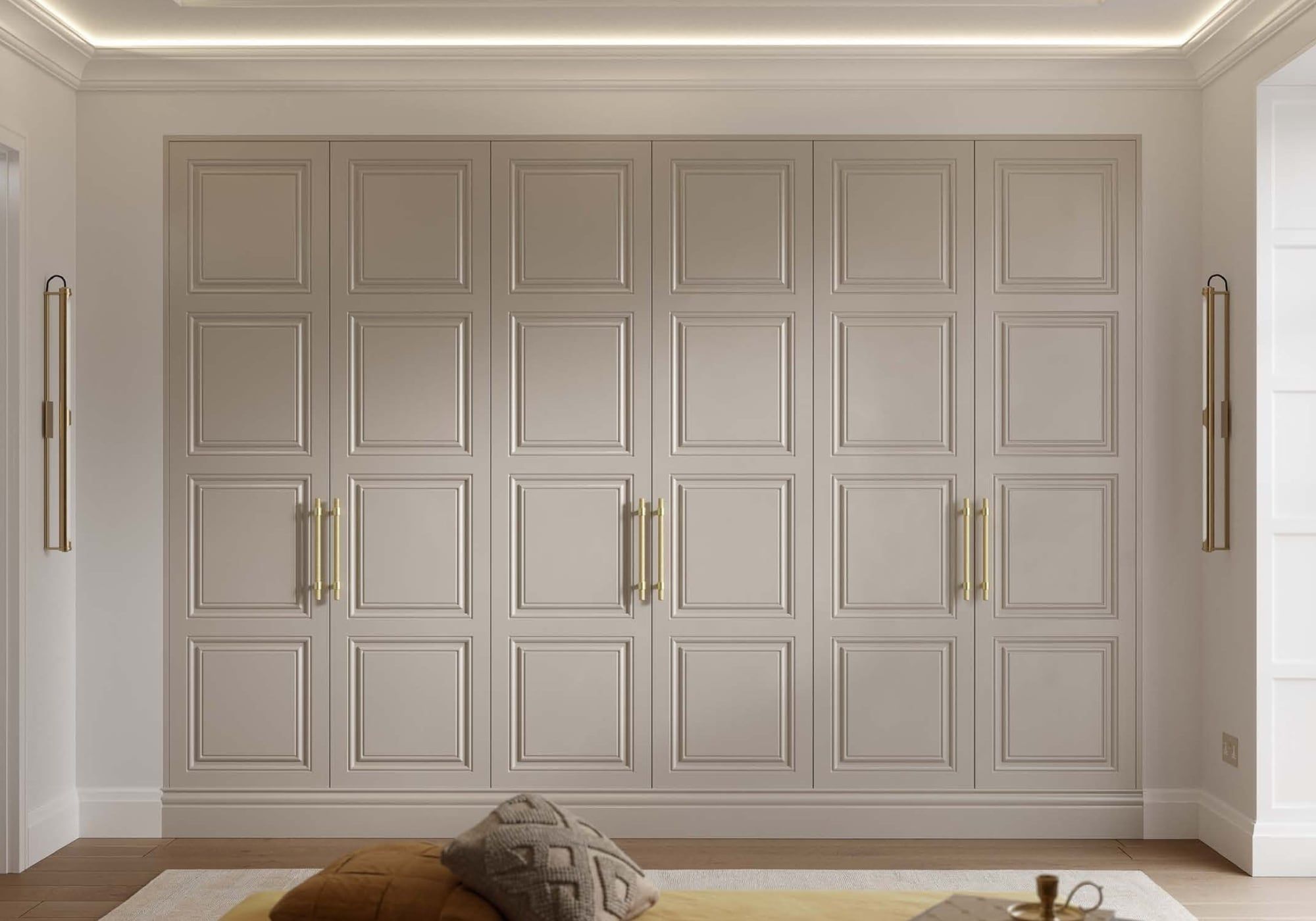 Panelled fitted wardrobes in a soft cream with brass handles, a brochure example of a classic door style