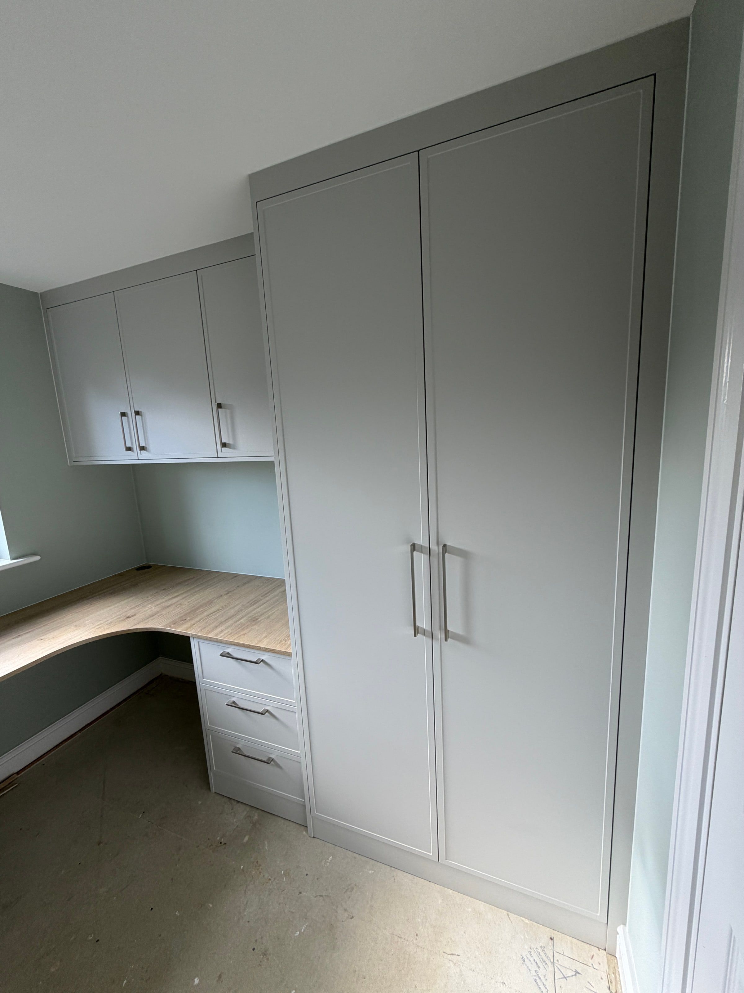 The full-height light grey Alpine Shaker cupboard beside the desk return, as fitted in the Hinckley home office