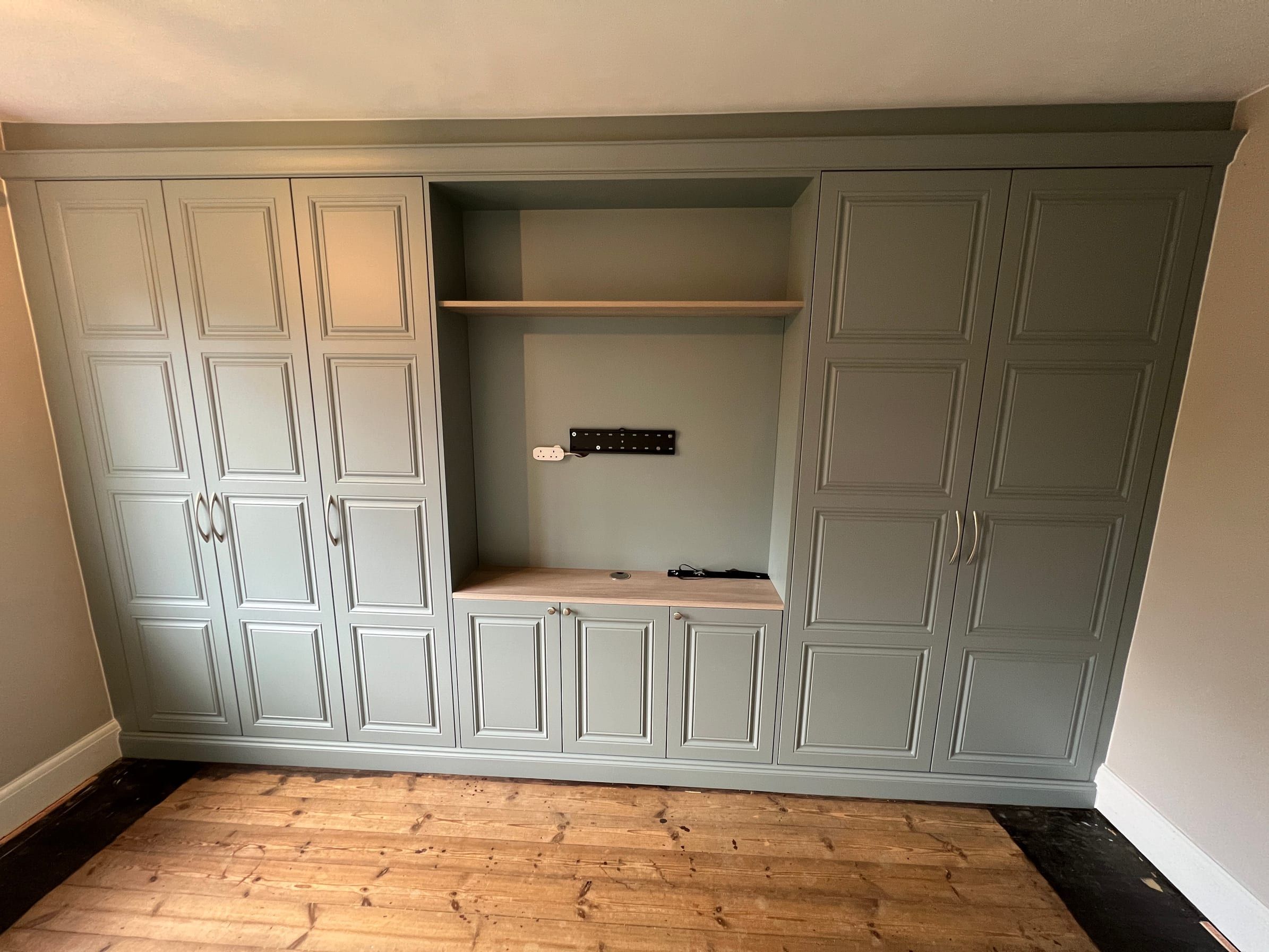 The Loughborough wardrobes as fitted: Fjord matt Harrington doors either side of an open section built around the chimney breast