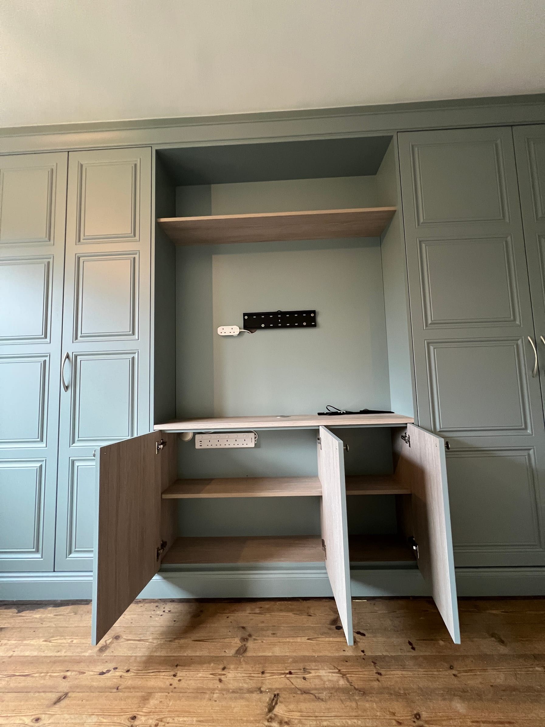 The low cupboards under the open section of the Loughborough wardrobes, with their doors open