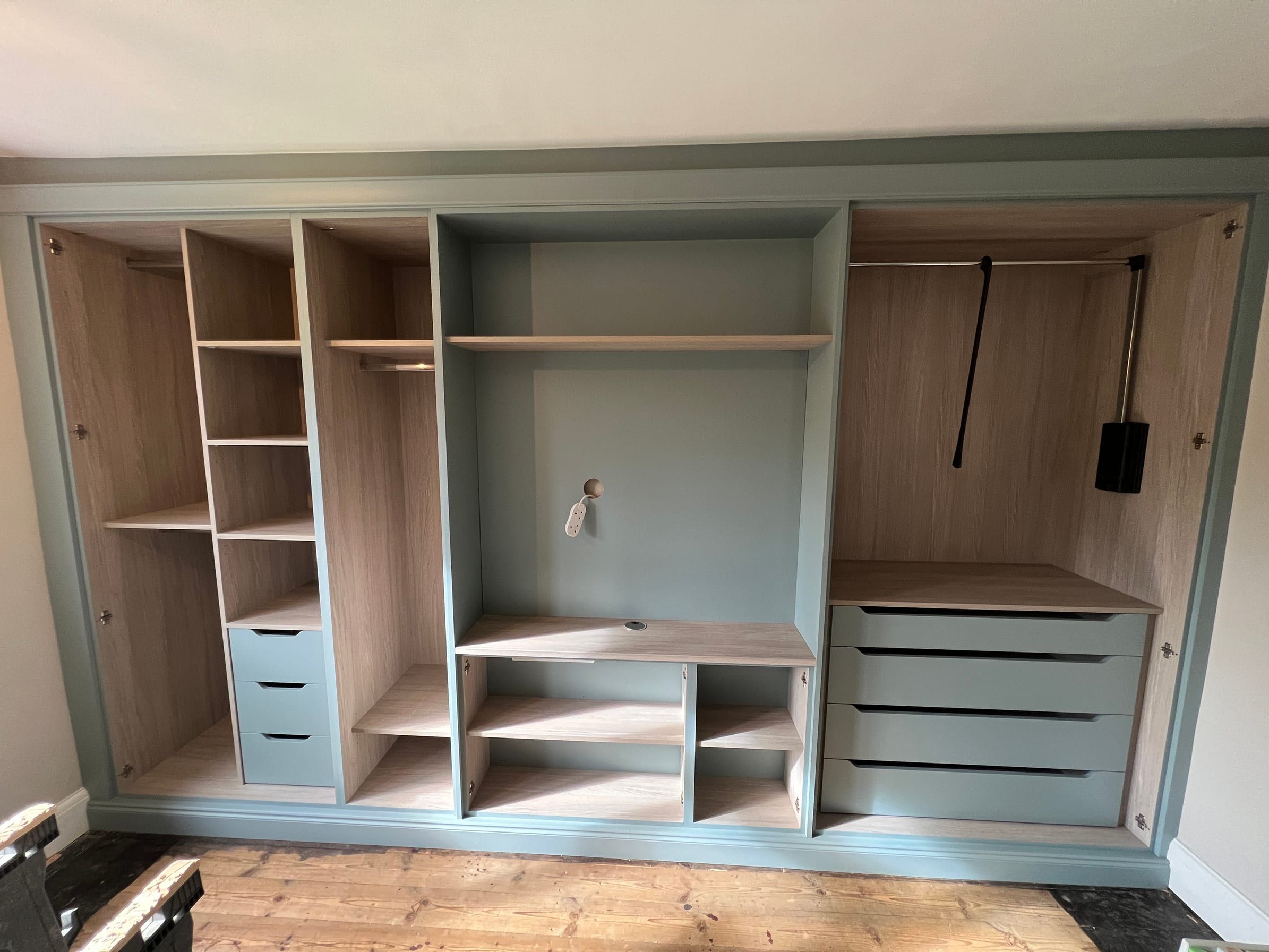 The Loughborough wardrobes before the doors went on, showing the shelves, drawers, hanging space and pull-down rail inside