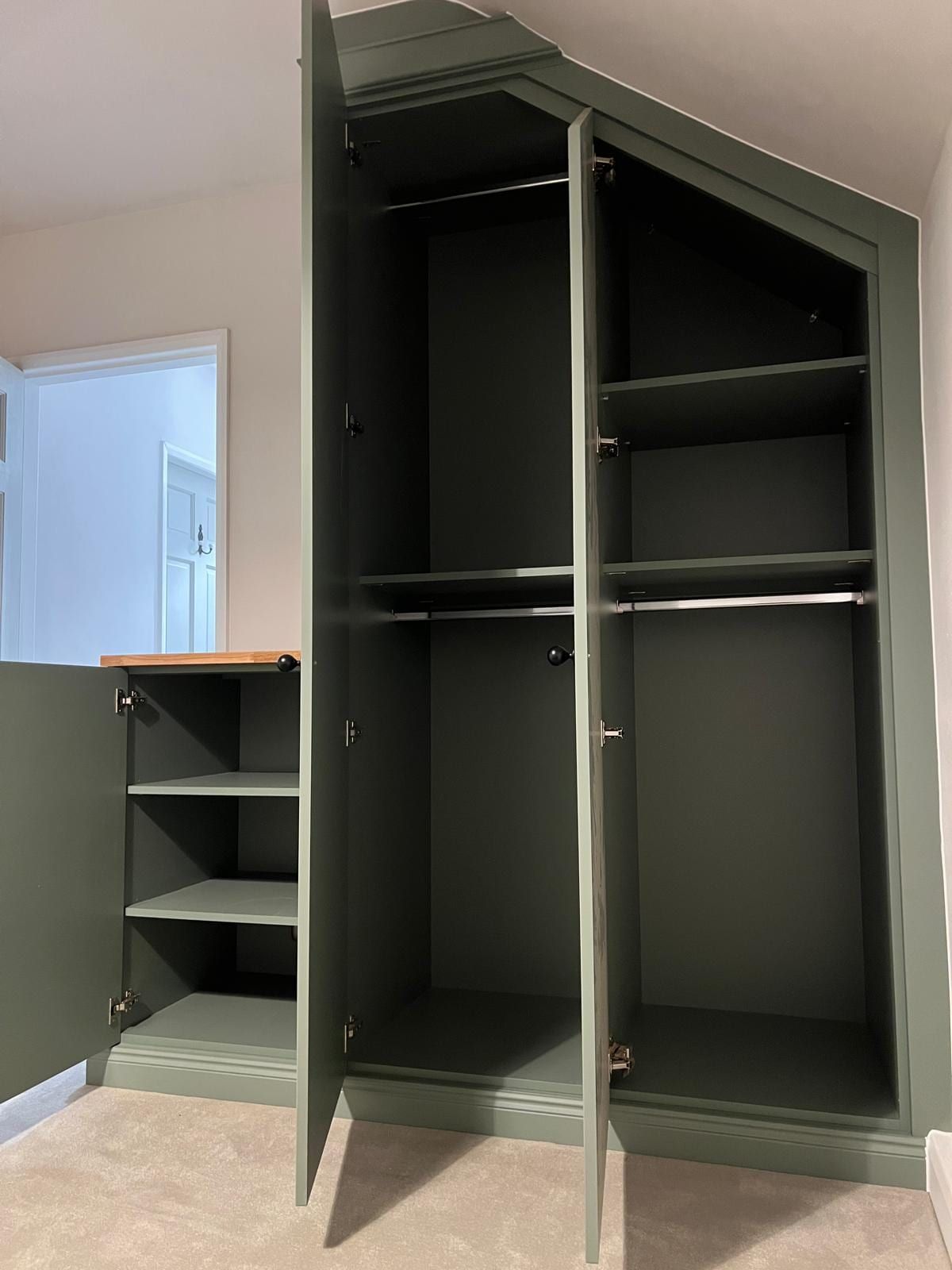 The Loughborough wardrobe open to show hanging rails and shelves, and the low cupboard with its shelves