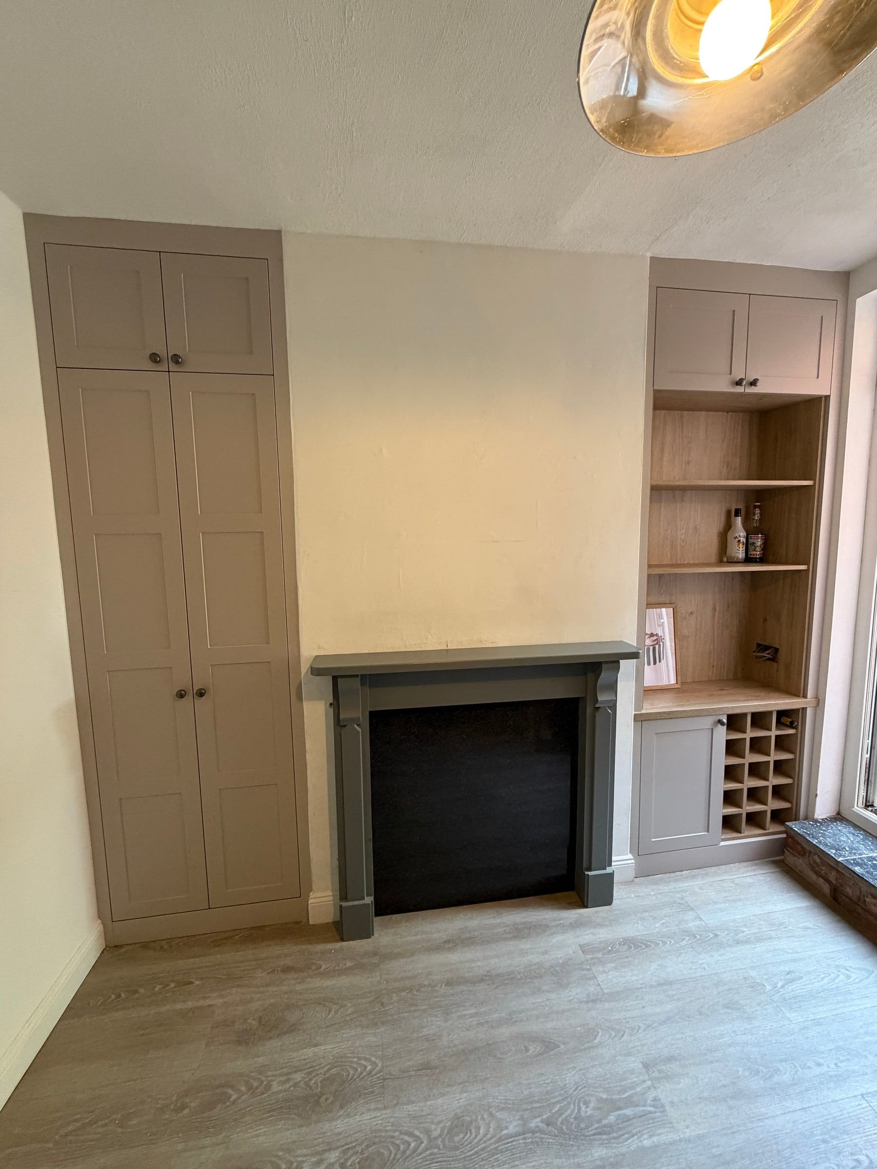 The Mountsorrel alcove units as fitted: a tall Cashmere shaker cupboard in one alcove, and a cupboard, open shelving, wine rack and base cupboard in the other