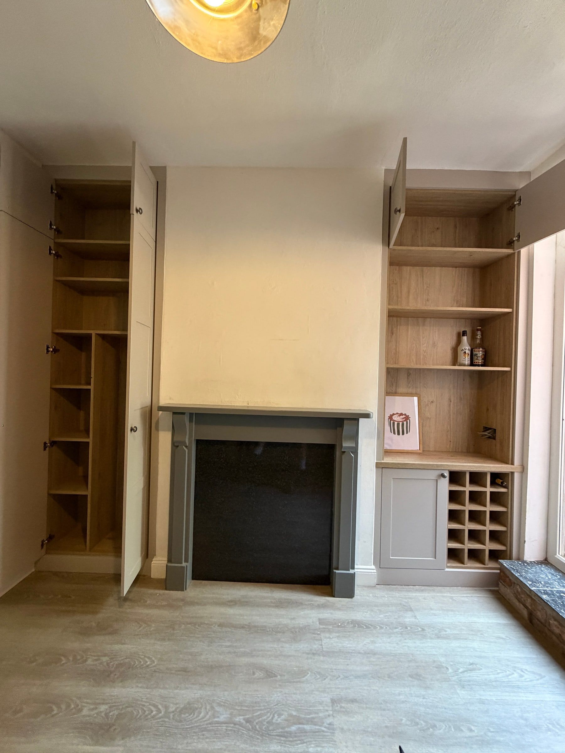 The Mountsorrel alcove units with the doors open, showing storage made for appliances in the tall cupboard and adjustable shelves in the other