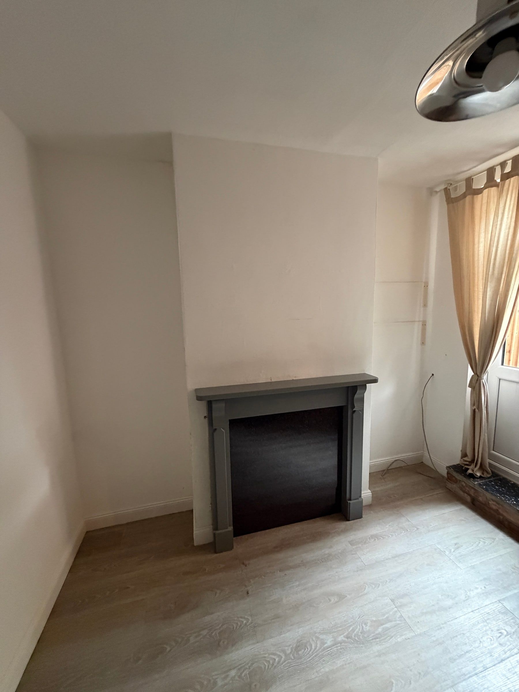 The Mountsorrel dining room before: empty alcoves either side of the fireplace