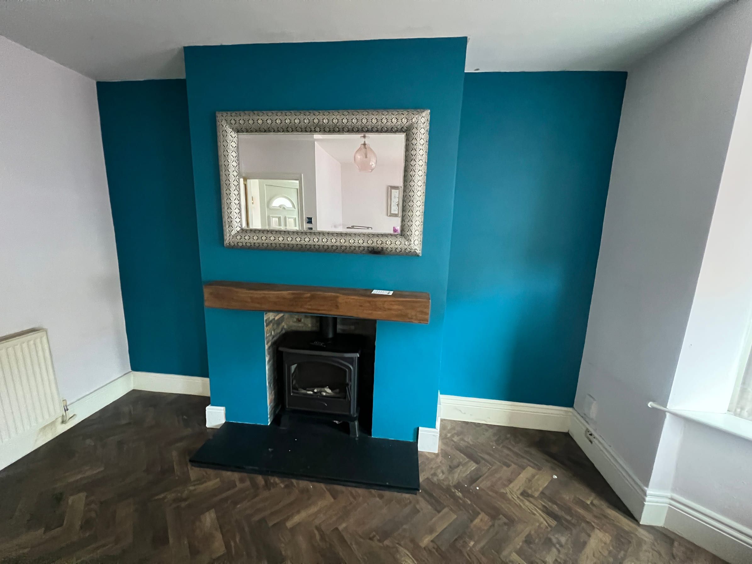 The Nottingham living room before: empty alcoves either side of the chimney breast and stove