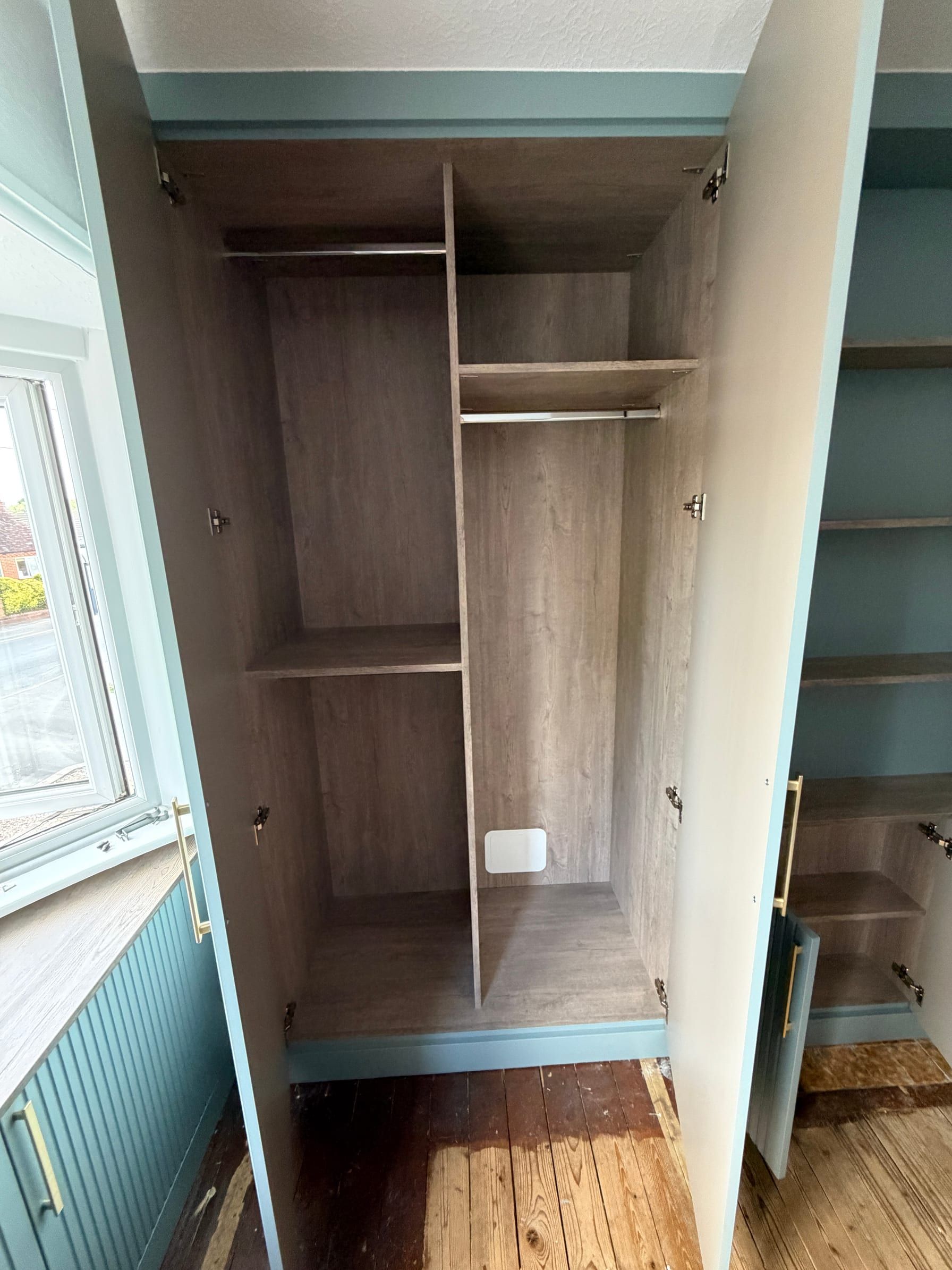 The low cupboards under the open shelving in the Sileby wardrobes, with their doors open