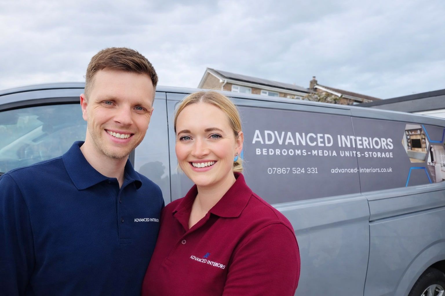 Aaran and Saffron of Advanced Interiors standing in front of their Advanced Interiors van